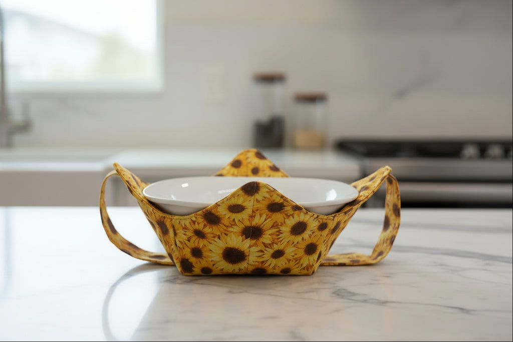 Sunflower Bowl Cozy with a strap sitting on a marble kitchen counter top