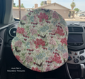 Floral patterned with butterflies on cream fabric covering a steering wheel