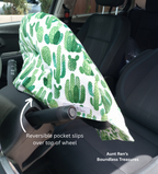 Green Cactus print on white fabric slipped over a steering wheel