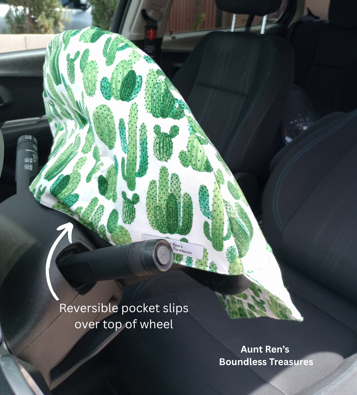 Green Cactus print on white fabric slipped over a steering wheel