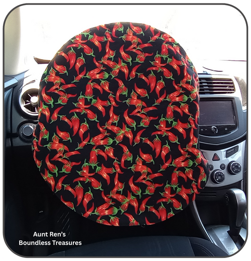chili peppers on black fabric covering a steering wheel
