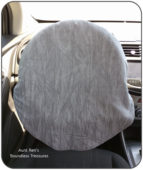 different shades of gray with lines resembling cracked ice fabric on a steering wheel