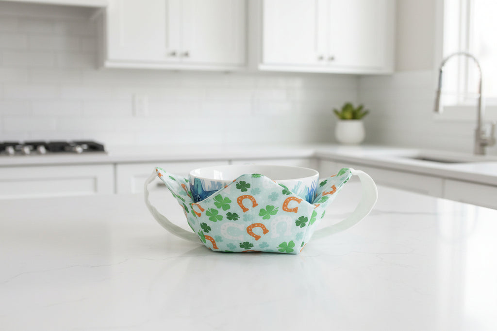bowl cozy with horseshoes and green clovers with a white strap.