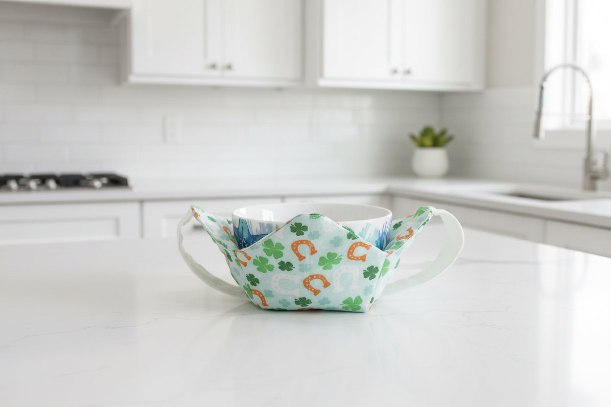 bowl cozy with horseshoes and green clovers with a white strap.