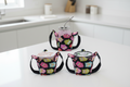 Set of three pint cozies holding different items: soup container, mason jar and ice cream with colorful owl pattern