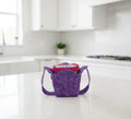 White Dragonflies on purple fabric in the form of a pint size cozy holding ice cream in a kitchen setting