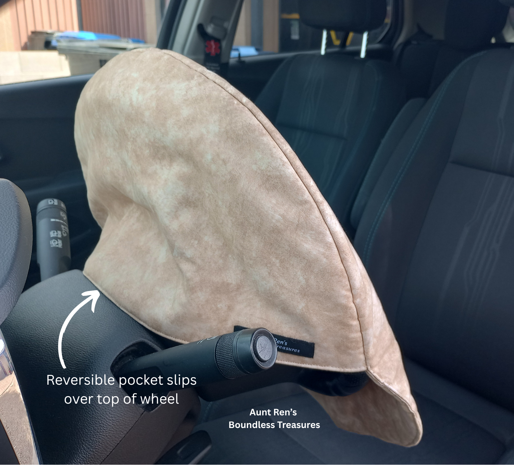 a Calico brown cover slipped over a steering wheel by Aunt Ren's Boundless Treasures