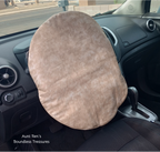 Calico brown fabric cover slipped over steering wheel of a car