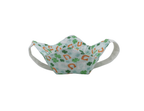 Fabric face bowl cozy with clover and horseshoe pattern on a white background