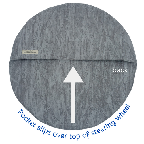 Gray steering wheel cover with a pocket on top, labeled 'back' and 'Pocket slips over top of steering wheel