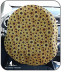 Sunflowers on yellow fabric covering a steering wheel