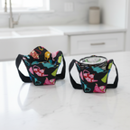 Decorative tea pots on black fabric, two cozies, one holding pint of ice cream.