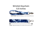 Wristlet keychain shown on a white background with text indicating dimensions: 5.5 inches long, a wrist loop circumference of approximately 11 inches, and an outer length of approximately 8 3/4 inches.