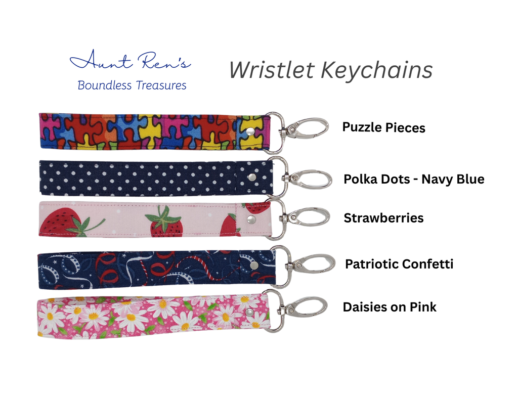 A product display showing four fabric wristlet keychains with silver lobster clasps, labeled with names and patterns: 'Puzzle Pieces,' 'Polka Dots - Navy Blue,' 'Strawberries,' and 'Patriotic Confetti,' plus 'Daisies on Pink.' The brand name 'Aunt Ren's Boundless Treasures' appears at the top left on a white background.