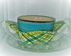Ceramic bowl with a green checkered bowl cozy in a microwave
